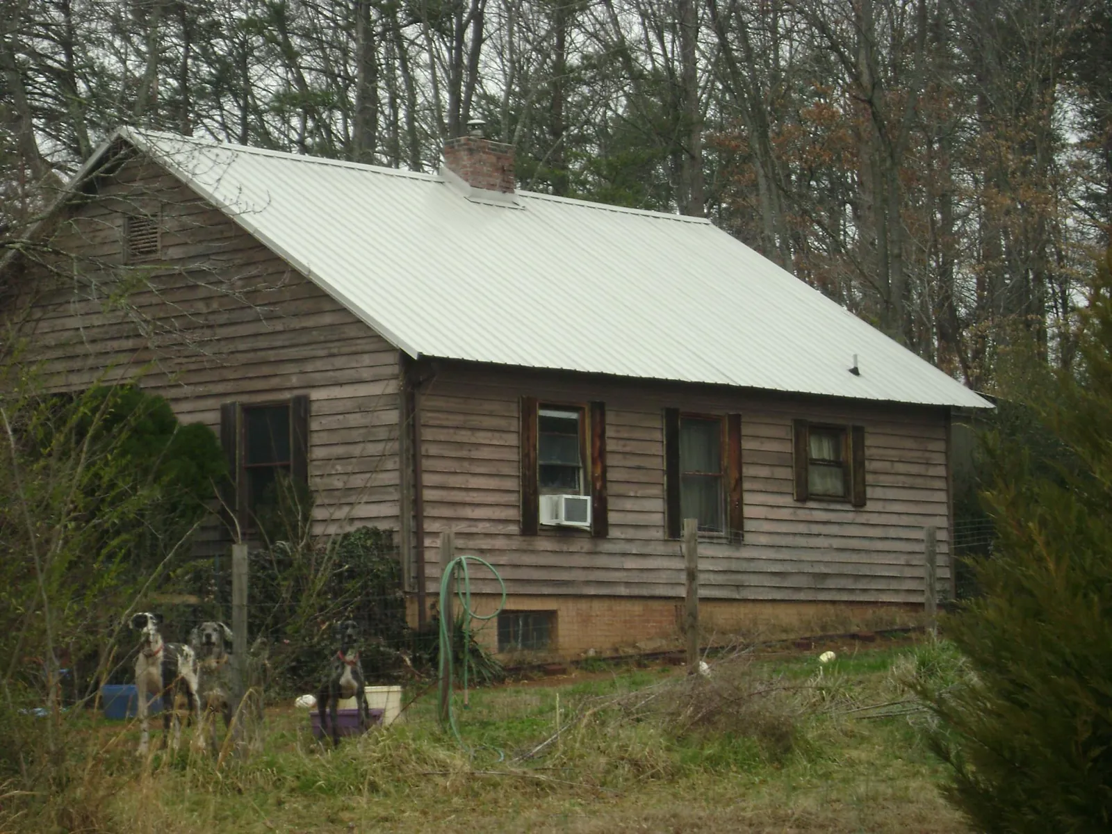 White metal roof on an old wood sided farmhouse, from a Metal Roof Installation job in Peck